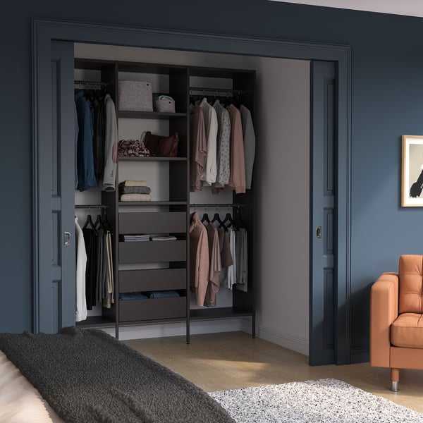 Modern black AURDAL wardrobe with shelves, drawers, & organised clothes between doors.