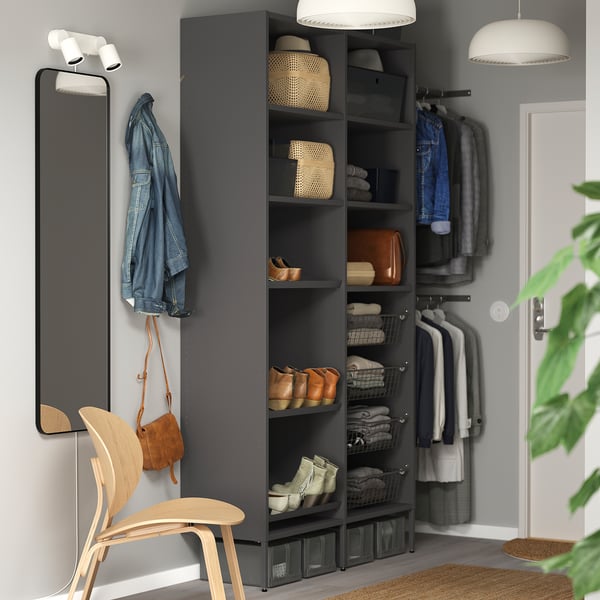 Modern walk-in closet with AURDAL grey storage units. Shelves, baskets, and hanging rails. Includes a tall mirror, wooden chair, and pendant lights.