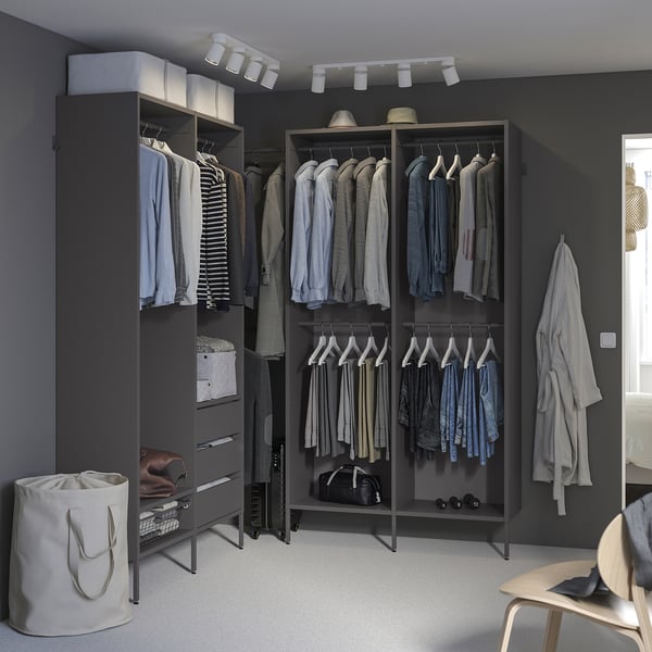 Grey closet organiser with shelves, drawers, hanging space, and top storage for hats and bags.