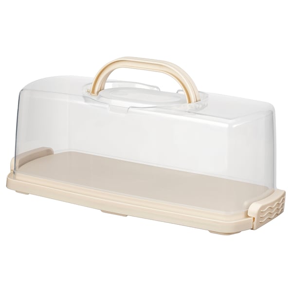 BAKTIDER beige cake keeper. Rectangular, clear lid with gold handle, beige base, snap-on latches.