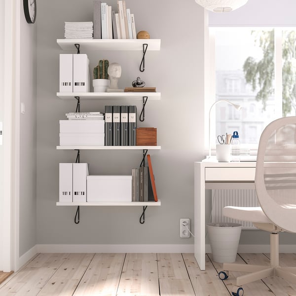 Home office with BERGSHULT shelves, light decor, and large window.