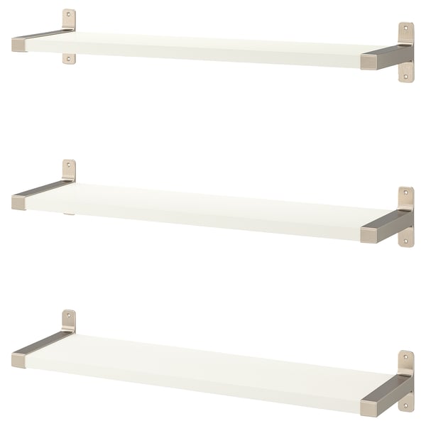White wall shelves with nickel brackets, minimalist design.