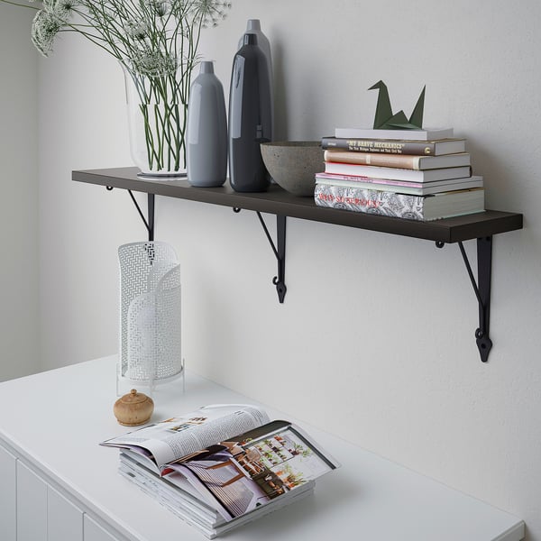 Wall shelf with vases, books, plant.