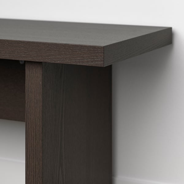 Dark wood bench corner, smooth finish, sturdy design.