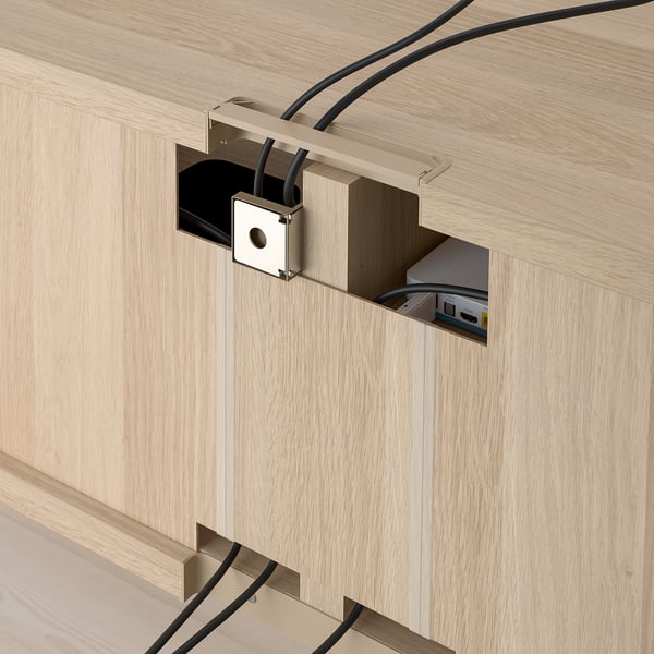 Cable management system for BESTÅ tv bench; wires routed through back compartments.