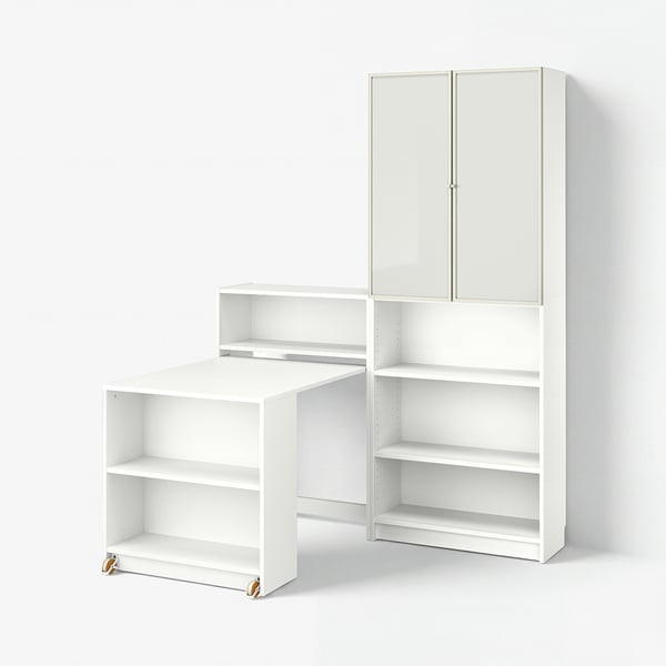 White BILLY bookcase with foldable table, combining open and closed storage, on casters.