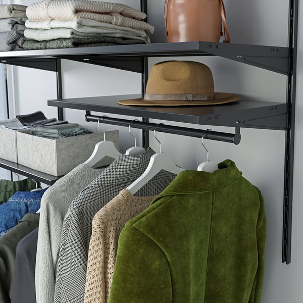 A closet shelf setup with clothes hangers and a hat on the top shelf, showing organised storage space.