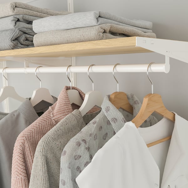 Organised closet with BOAXEL. Shelves hold folded clothes, while hanging rods support sweaters and tops.