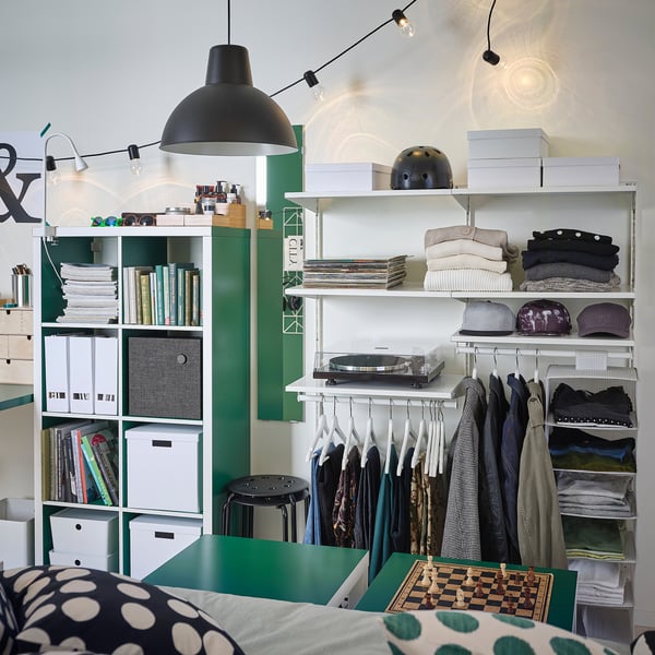 Modern green BOAXEL storage: clothes, books, records, hats, chess board, lights.