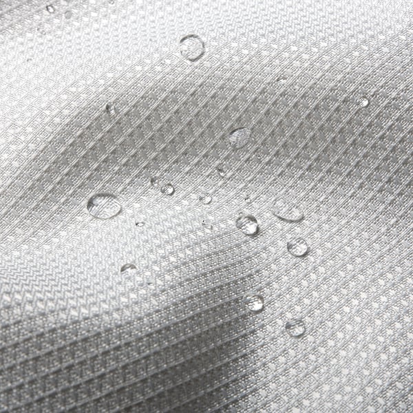 Water droplets bead on waffle-textured curtain, showcasing its water-repellent fabric.