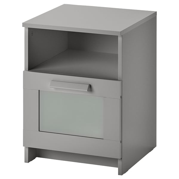 Grey BRIMNES side table with open top shelf, single drawer, and glass front panel.