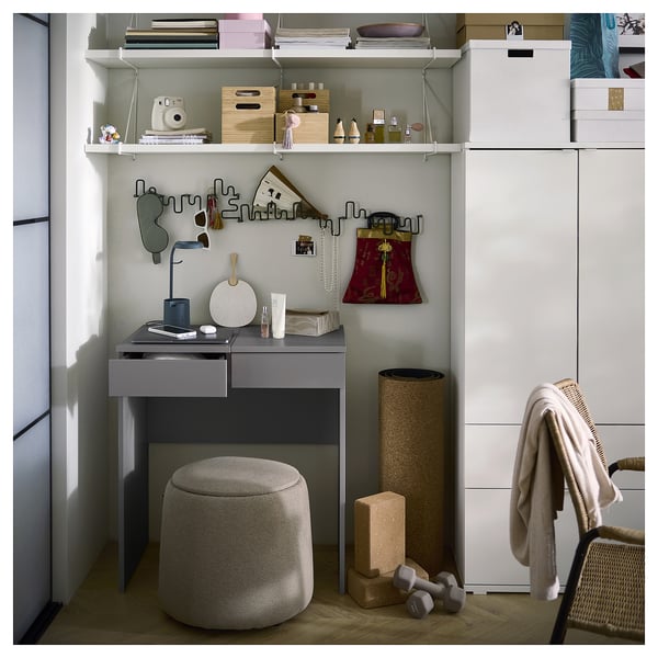 Modern home office with grey BRIMNES desk, grey stool, white shelves, and wall hooks.