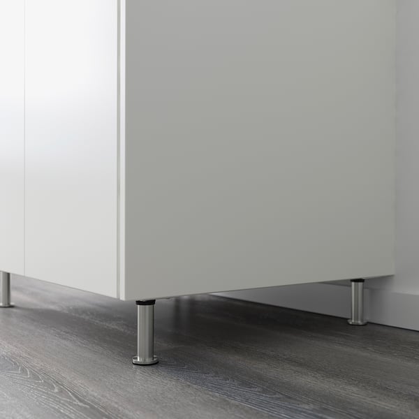 Kitchen cabinet supported by adjustable metal legs.