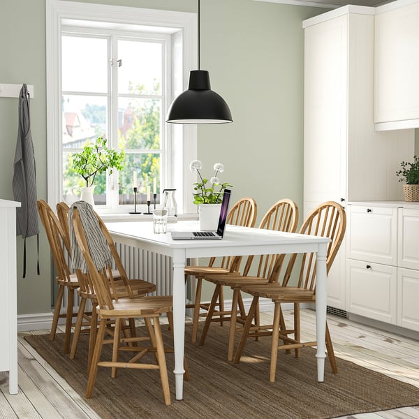DANDERYD white 6-seat dining set, featuring rustic wooden chairs and sturdy steel table legs, perfect for modern homes with ample space.