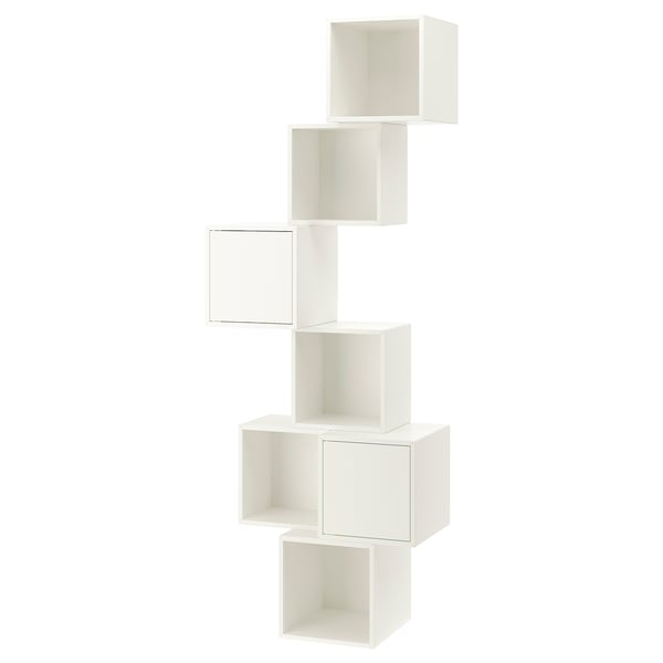 A white, wall-mounted EKET storage unit with multiple compartments. It has a modern, minimalist design with asymmetric, staggered shelves.
