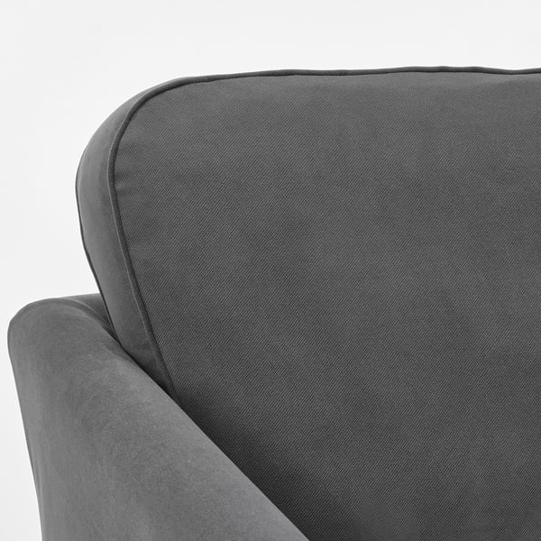 Close-up of a modern, grey upholstered sofa corner, showcasing quality fabric and stitching.