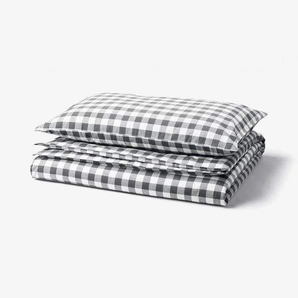 A folded black and white gingham check duvet cover set made of 100% organic cotton.
