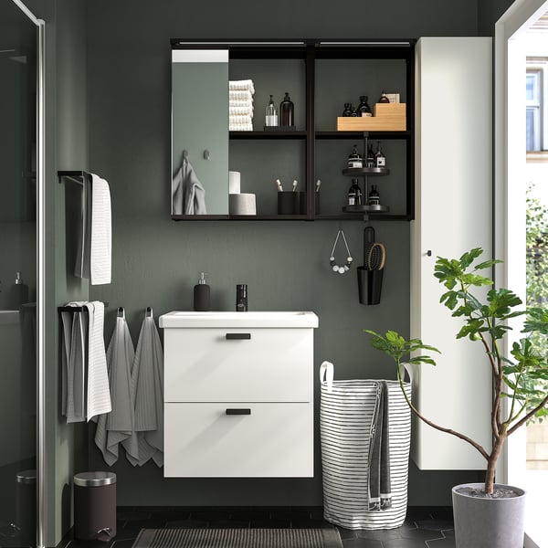 White ENHET cabinet near sink, towels and toiletries.