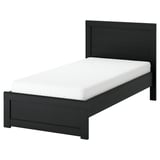 A FÅGELFJÄLLET black oak bed with a white mattress, featuring a simple, elegant design and a slightly wider footboard.