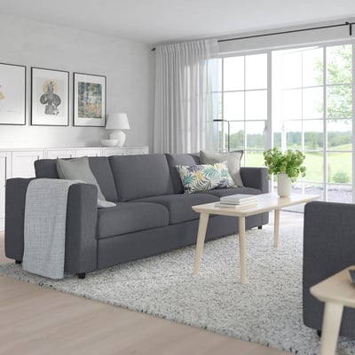 Modern living room with FINNALA sectional sofa, coffee table, and bright windows.