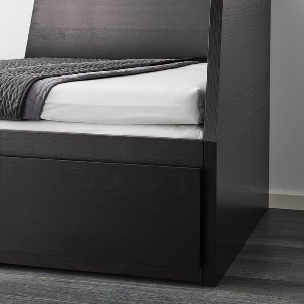 Modern black wooden day-bed with white mattress, converting into a sofa or double bed for flexibility and space-saving.