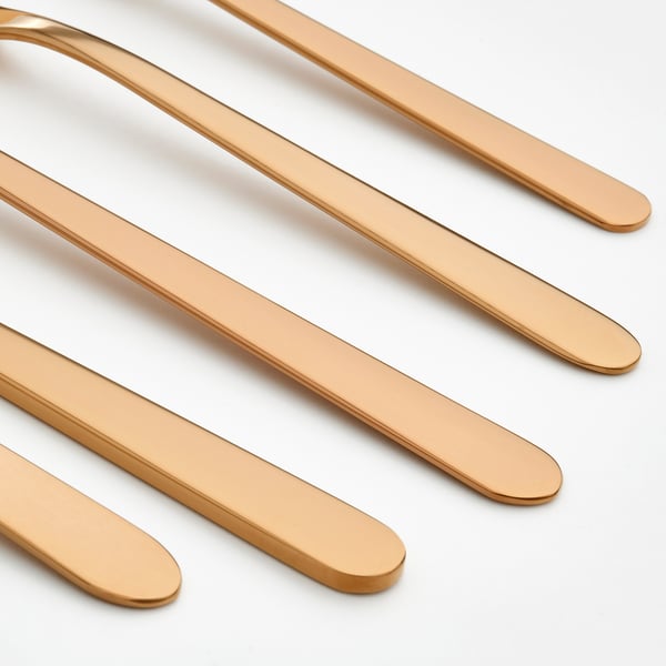 Golden cutlery set, sleek design. Six cutlery pieces, polished finish, arranged diagonally. High-quality stainless steel, elegant look.