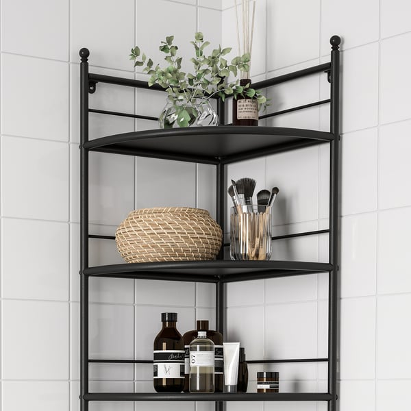Black corner shelving unit with three shelves. Holds vase, brushes, and bottles in bathroom.