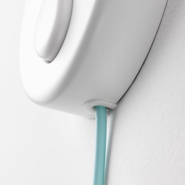 White lamp with turquoise cord, mounted on wall, featuring sleek design, safe for children.