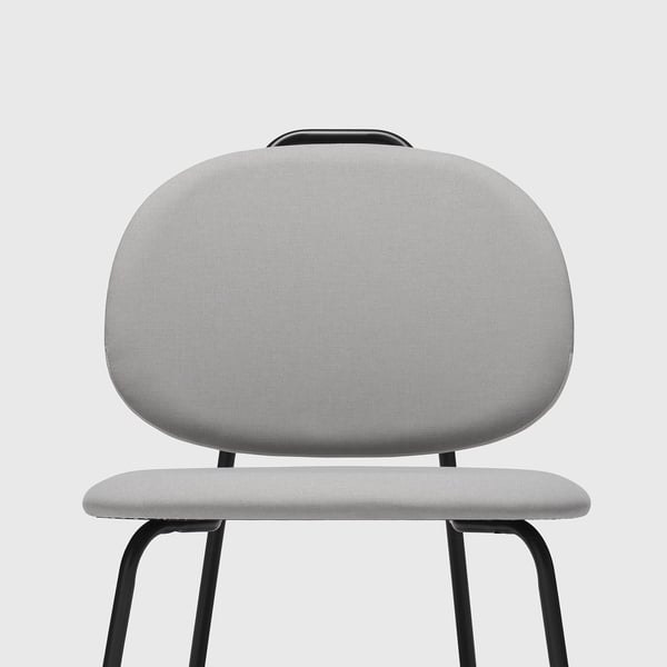 Modern grey chair with curved back and upholstered seat, supported by a sturdy metal frame. Ideal for comfort and style.