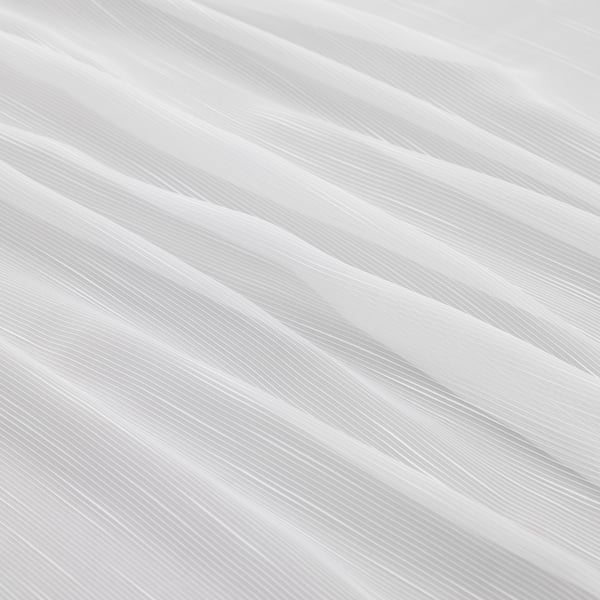 Sheer, recycled polyester curtains, offering privacy and natural light. Diagonal lines create a modern pattern.