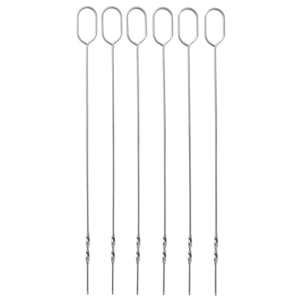 Six stainless steel skewers with flat design, hanging loops, and sharp tips, arranged in a row.