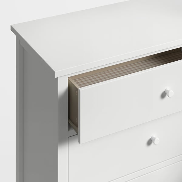 White GULLABERG chest with rounded knobs and checked liner drawers.