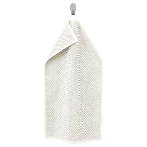 A beige GULVIAL towel, made of soft cotton, hanging. It is rectangular with a textured surface, featuring a hook at the top.