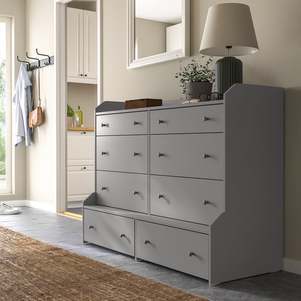 Grey HAUGA chest with 9 drawers, shelf, bench. Decorated top, hooks, mirror above.