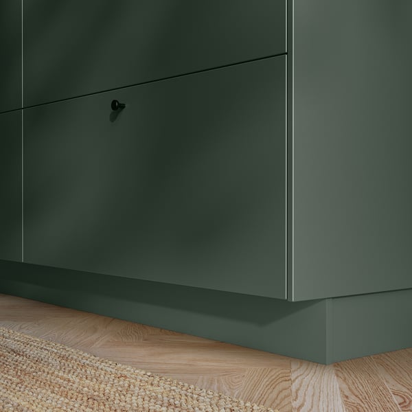 Dark green kitchen cabinet with sleek, straight lines and smooth surface. Modern design with hidden handle.