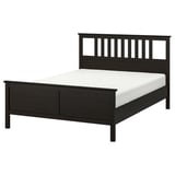 A HEMNES bed in dark brown stain with a headboard, white mattress, and solid pine construction.