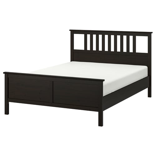 A HEMNES bed in dark brown stain with a headboard, white mattress, and solid pine construction.