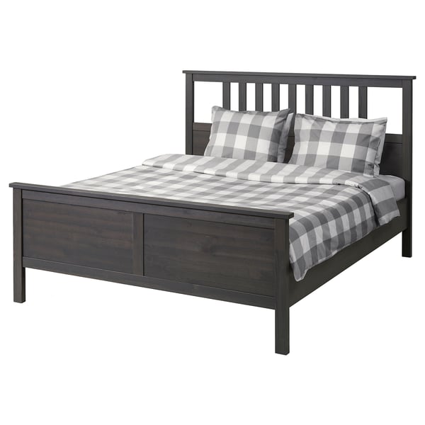 Dark wood HEMNES bed with grey checked bedding.