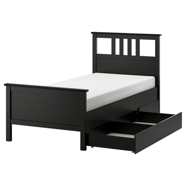 Black HEMNES bed with storage. Wooden frame, rectangular, sleek design, one open drawer.