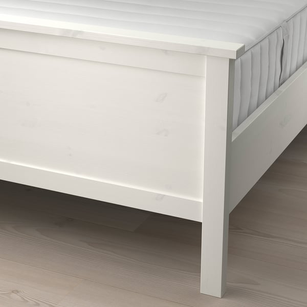 White wooden bed with adjustable slats, providing support and comfort for mattresses.