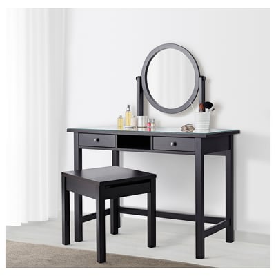 Black dressing table set with mirror, stool, and storage for makeup.