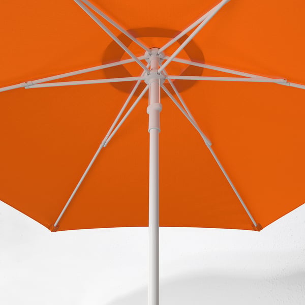 Bright orange parasol open against white sky. Robust metal frame, secure locking mechanism, and vibrant colour.