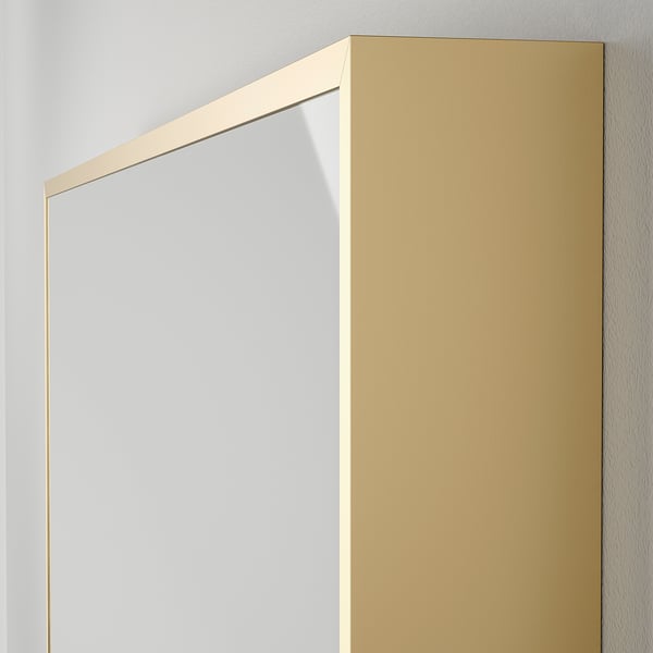 Large rectangle mirror with sleek gold frame, leaning against white wall. High quality, modern design.