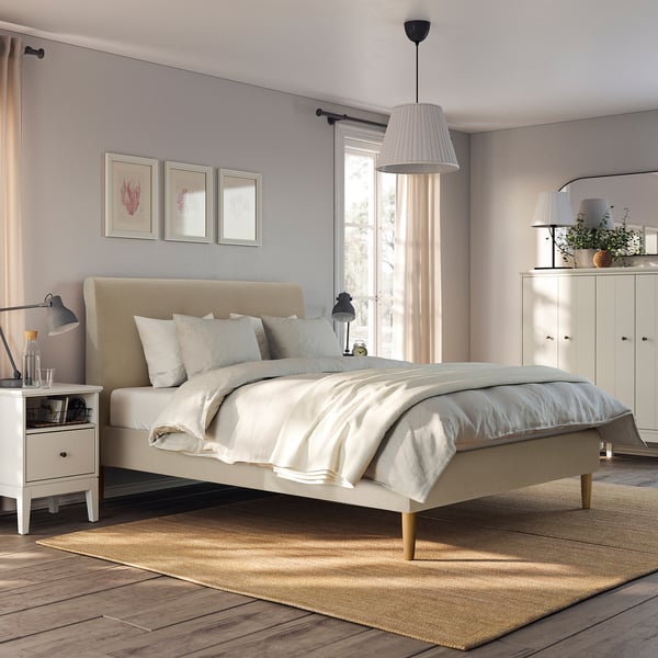 Modern bedroom with IDANÄS bed, nightstands, and large windows.