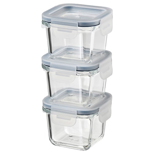 Three stacked clear square glass IKEA 365+ food containers with blue lids.