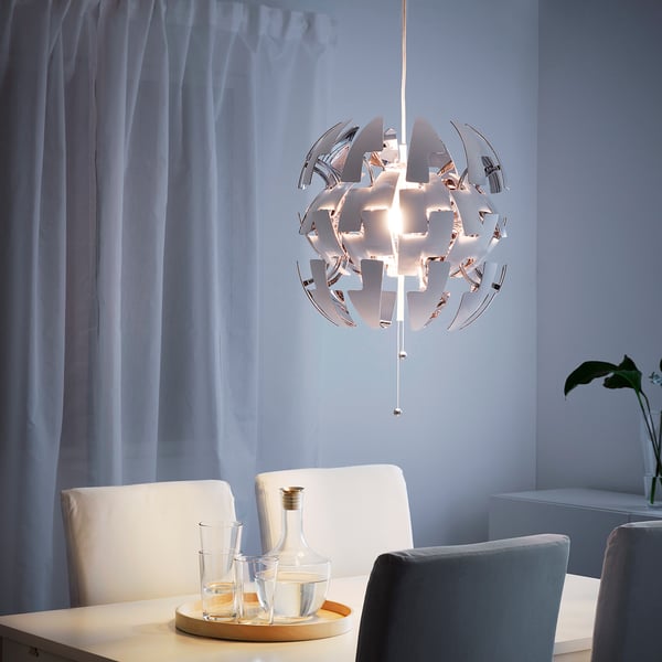 Modern dining room with pendant lamp and blue curtains.