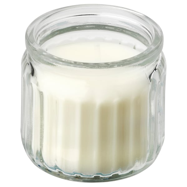 A JÄMLIK scented candle in a clear glass jar, filled with white wax. The jar is cylindrical with a ribbed design.