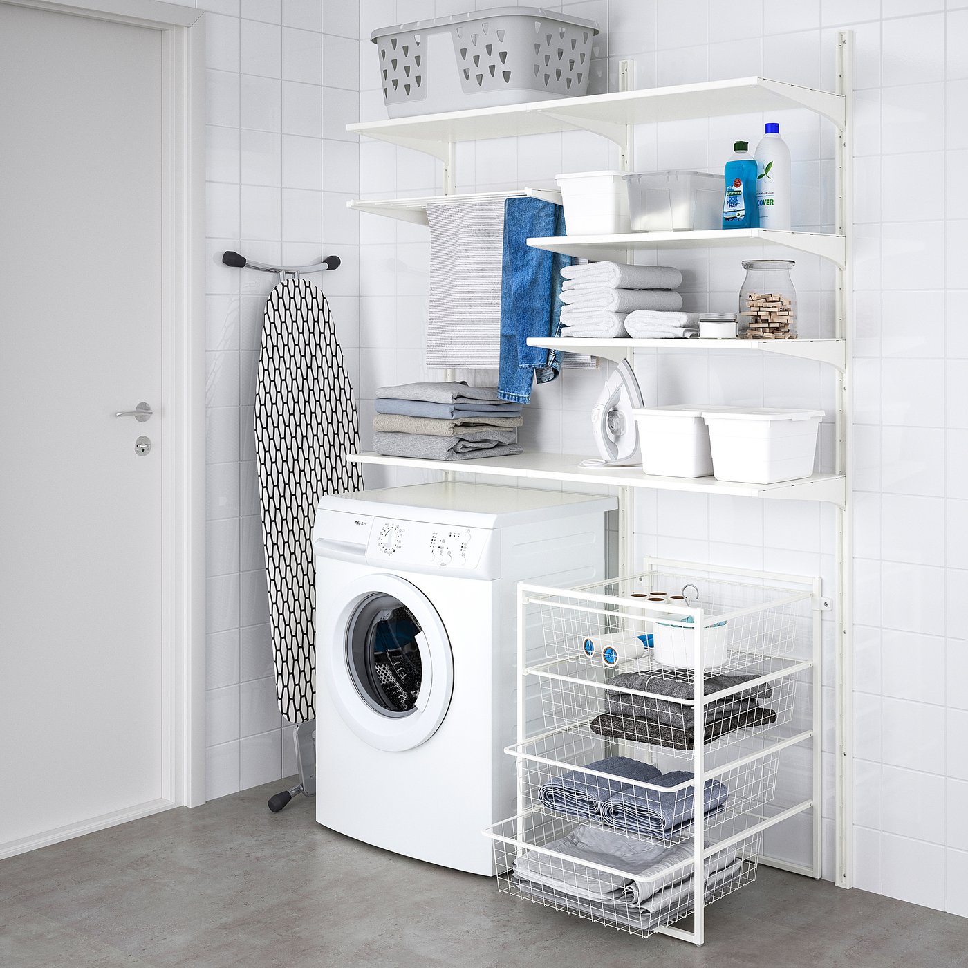 Laundry room with JONAXEL shelves holding towels, detergent, basket, washing machine, and ironing board.