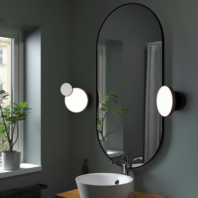 KABOMBA black wall lamp with oval mirror & dual lights in bathroom.
