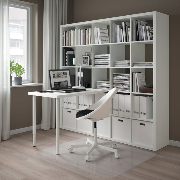 Modern KALLAX desk with open/closed storage, chair, laptop, plant.
